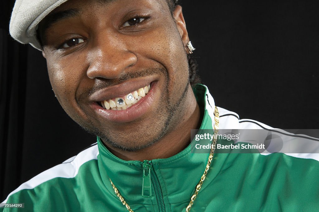Portrait of young man with diamonds in teeth