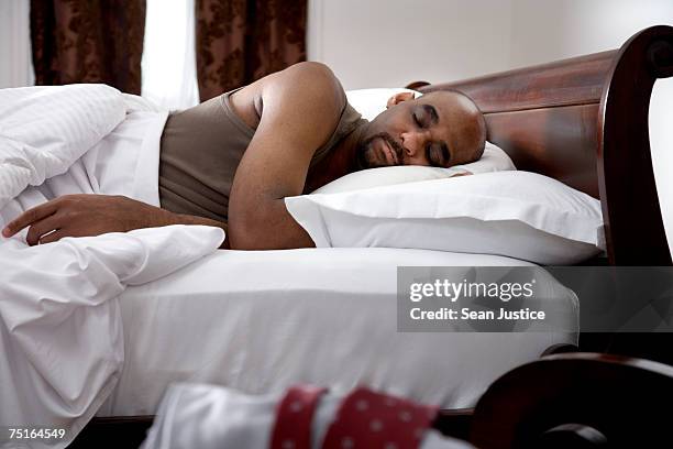 mature man sleeping in bed - acostado de lado fotografías e imágenes de stock