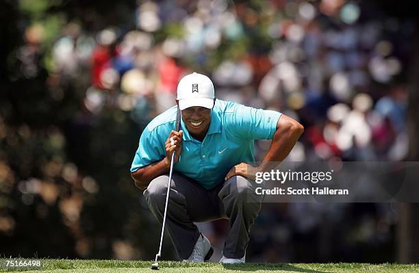 Tiger Woods waits to putt on the ninth green during the second round of the AT&T National at Congressional Country Club on July 6, 2007 in Bethesda,...