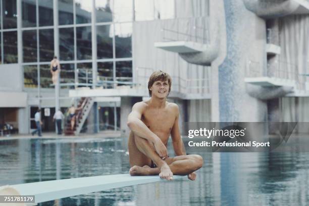 English diver Chris Snode pictured sitting on a springboard at the Olimpiysky Sports Complex swimming pool during competition for the Great Britain...