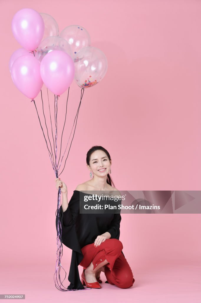 Female model holding a balloon