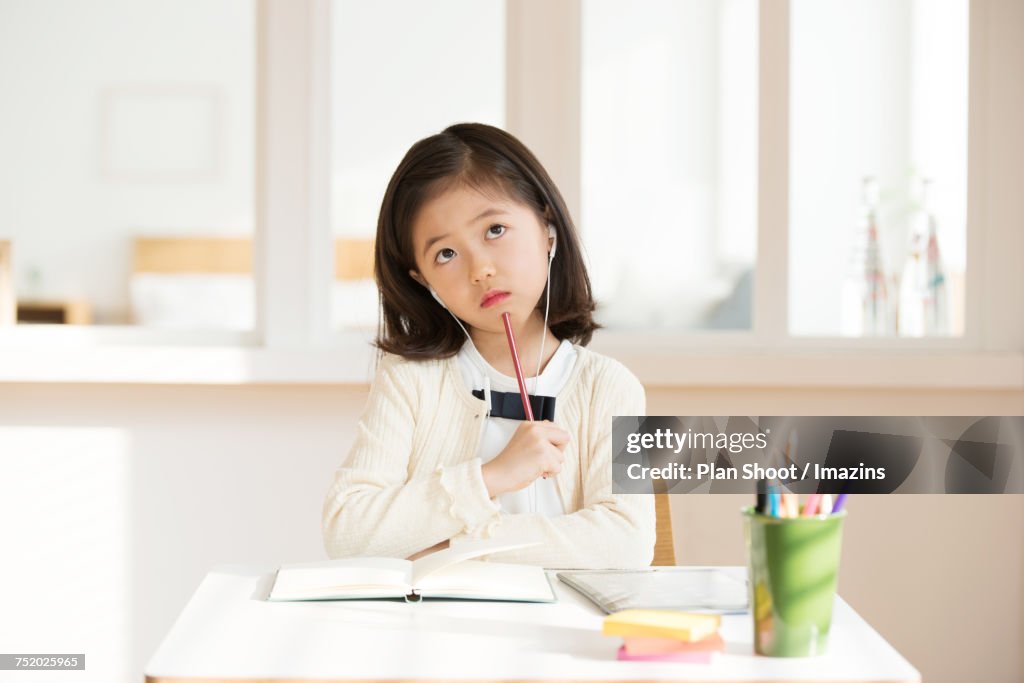 Girl studying sitting at desk