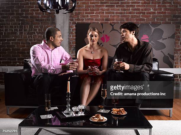 two men and woman having drinks - three people at table stock pictures, royalty-free photos & images