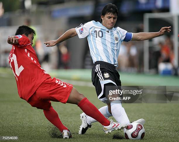 Argentina's Sergio Aguero fights for the ball with North Korea's Kuk Jin Kim during their match at the FIFA U-20 World Cup on 06 July 2007 in Ottawa,...