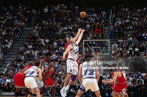 Greg Ostertag of the Utah Jazz battles Luc Longley of the Chicago Bulls for the jumpball in Game One of the 1998 NBA Finals at the Delta Center on...