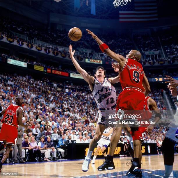 John Stockton of the Utah Jazz shoots a layup against Ron Harper of the Chicago Bulls in Game Two of the 1998 NBA Finals at the Delta Center on June...