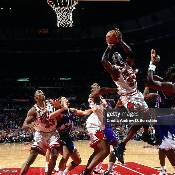 Michael Jordan of the Chicago Bulls attempts a layup against Karl Malone of the Utah Jazz in Game Five of the 1998 NBA Finals at the United Center on...