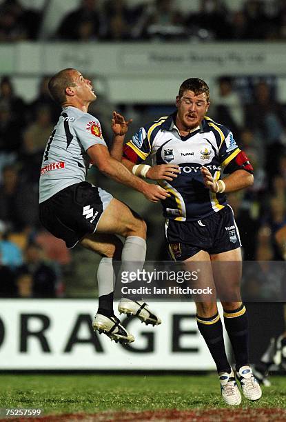 Grant Rovelli of the Warriors collides with Steve Southern of the Cowboys after he completed a clearing kick during the round 17 NRL match between...