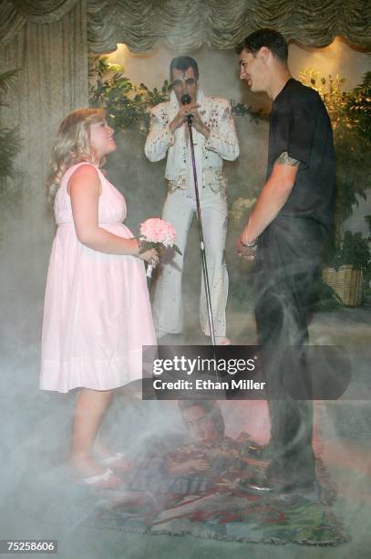 Hannah Kleinhaus and Jack Burch of Wyoming are married by Elvis Presley impersonator Brian Mills at the Viva Las Vegas Wedding Chapel July 7, 2007 in...