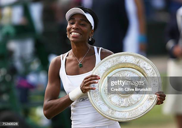 Venus Williams of USA poses with the trophy following her victory during the Women's Singles final match against Marion Bartoli of France during day...