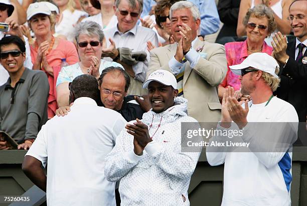 Richard Williams, father and coach of Venus Williams of USA hugs Walter Bartoli, father of Marion following the Women's Singles final match between...