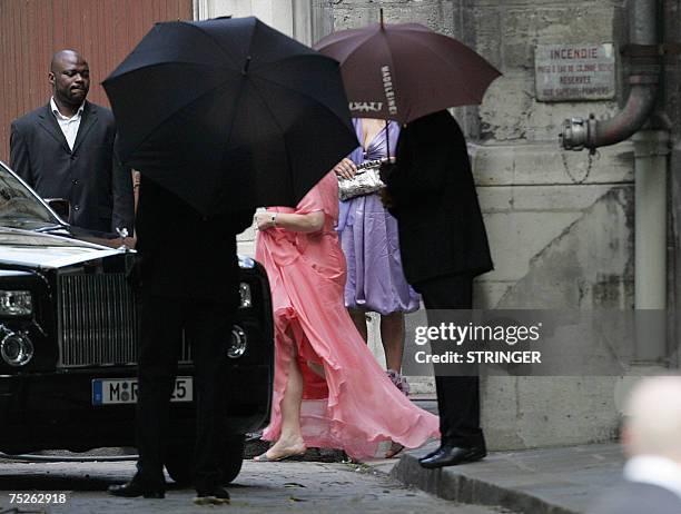 Superstar Tony Parker's mother Pamela Firestone is hidden by umbrellas as she leaves the Saint-Germain l'Auxerrois church after attending the wedding...