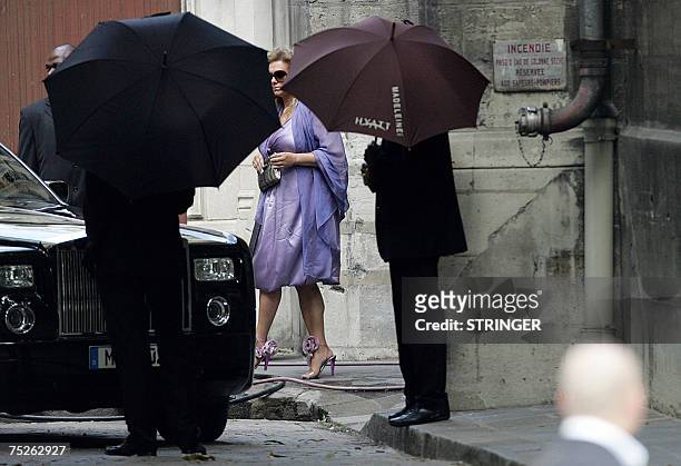 Superstar Tony Parker's mother Pamela Firestone is hidden by umbrellas as she leaves the Saint-Germain l'Auxerrois church after attending the wedding...