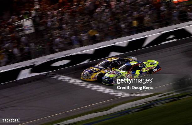 Jamie McMurray, driver of the IRWIN Marathon Tools Ford, crosses the finish line ahead of Kyle Busch, driver of the CARQUEST/Kellogg's Chevrolet, to...