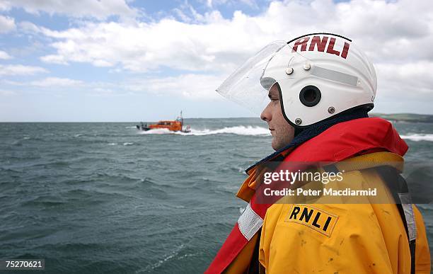 Volunteer crewman James Chadwick stands on the deck of The Swanage Lifeboat in near Poole Harbour on July 6, 2007 in Dorset, England.The Royal...