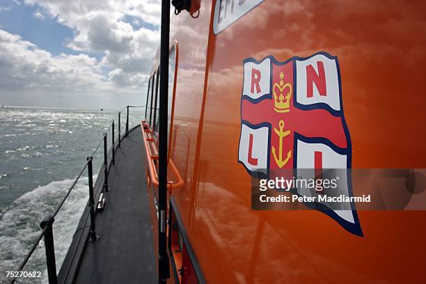 Flag is displayed on the side of an experimental fast Carriage Lifeboat off Poole Harbour on July 6, 2007 in Dorset, England. The Royal National...
