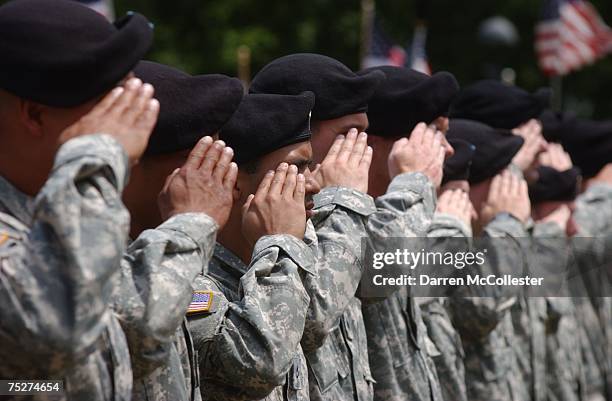 Soldiers with C Company, First Battalion of the 181st Infantry Regiment of the Massachusetts National Guard stand at attention during a deployment...