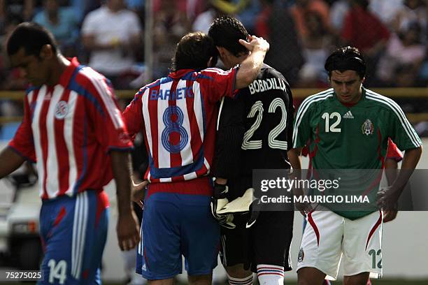 Paraguay's goalkeeper Aldo Bobadilla is conforted by teammate Edgar Barreto after receiving the red card during their Copa America 2007 quarterfinals...