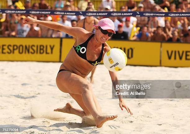 Jennifer Boss dives for the ball against Nicole Branagh and Elaine Youngs in the finals of the the AVP Seaside Heights Open on July 8, 2007 at...