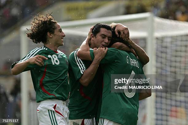 Mexico's Gerardo Torrado celebrates his goal against Paraguay, the second of his team, with teammates Juan Cacho and Andres Guardado during their...