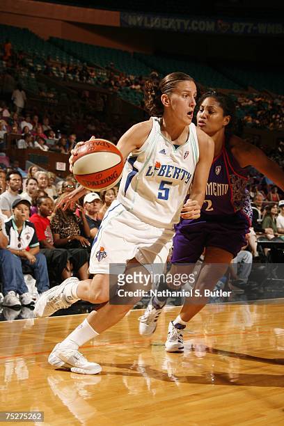 Erin Thorn of the New York Liberty drives against Chelsea Newton of the Sacramento Monarchs at Madison Square Garden July 8, 2007 in New York City....