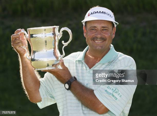 Brad Bryant holds up his trophy after winning the United States Senior Open at Whistling Straits July 8, 2007 in Kohler, Wisconsin. Bryant finshed at...