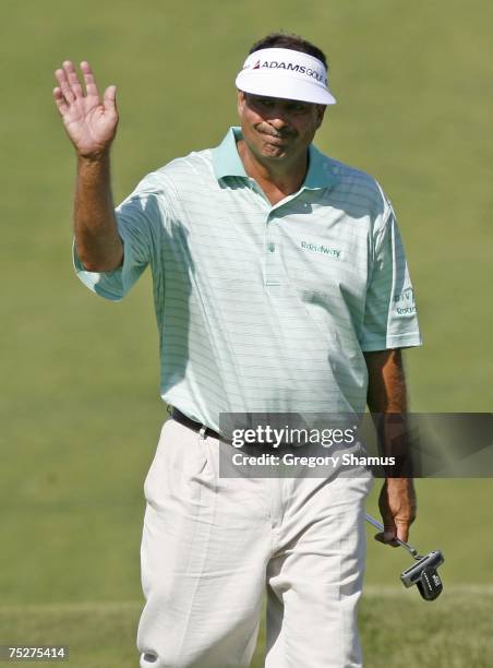 Brad Bryant waves to the fans while walking onto the 18th green during the final round of the United States Senior Open at Whistling Straits July 8,...