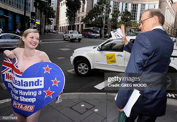 Lana Went , an activist from the animal rights organisation, People for the Ethical Treatment of Animals , smiles after handing a pamphlet to former...