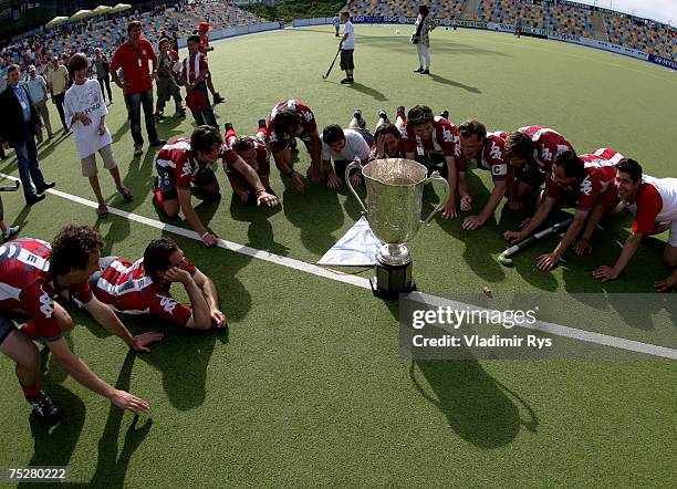 Club an der Alster team lays on the field with the trophy for the German Field Hockey Champion after winning the men?s final match against...