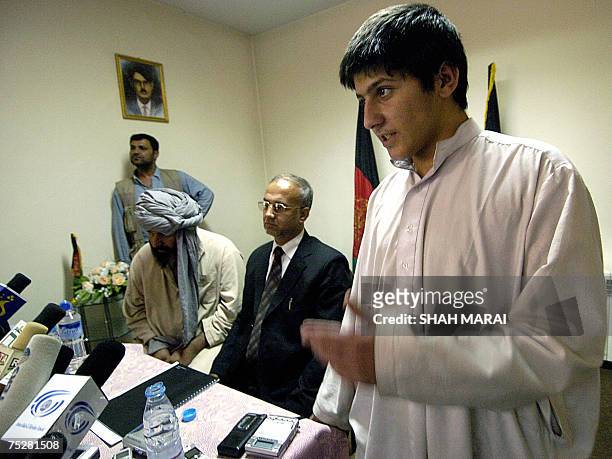 Pakistani youth Rafiq-Ullah speaks during a press conference at the intelligence office in Kabul, 09 July 2007, as his father Mati-Ullah looks on. A...