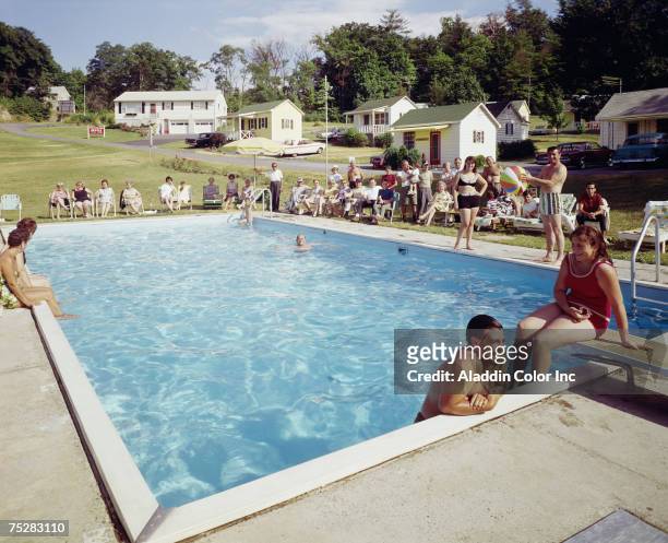 View of vacationers gathered by the side of the outdoor pool at the Astoria Motor Court, Leeds, New York, 1960s.