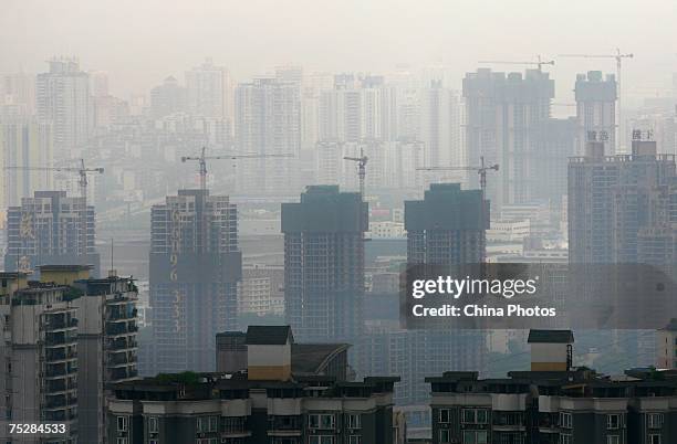 Property projects under go construction in downtown area on July 9, 2007 in Chongqing Municipality, China. According to state media, investment in...