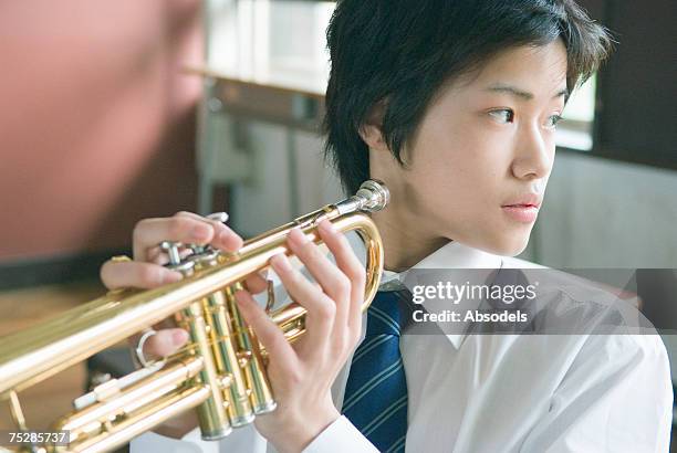 a student with a trumpet - blaasinstrument stockfoto's en -beelden