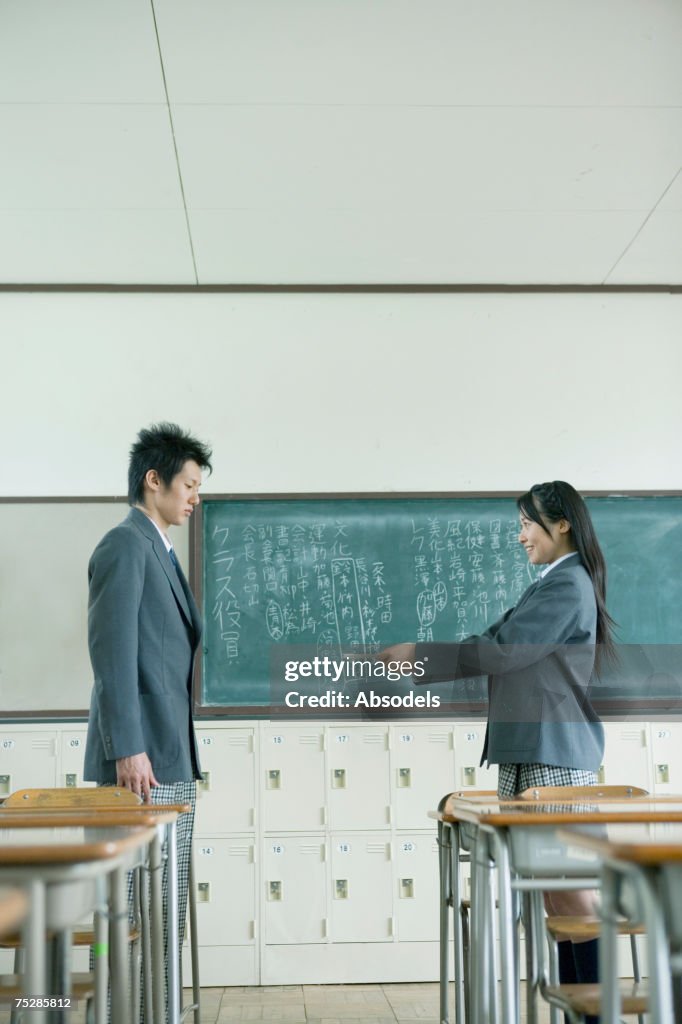 A girl students handing a letter to her classmate