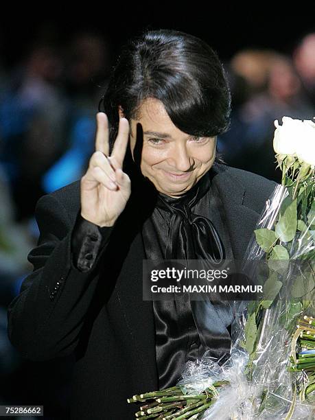 Moscow, RUSSIAN FEDERATION: Russian fasion designer Valentin Yudashkin shows the V-sign after presenting his new haute couter fall-winter 2007-2008...