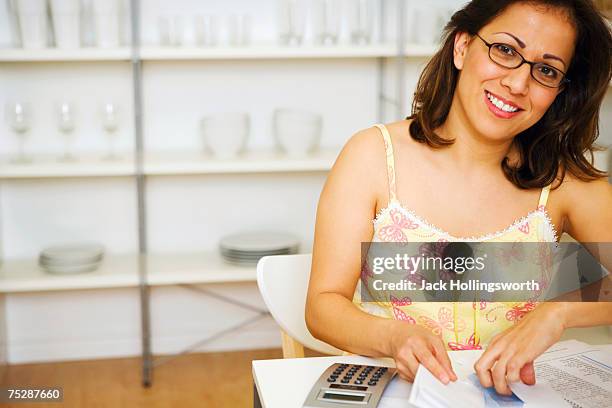 mid adult woman wearing glasses, smiling, portrait - table font view stock pictures, royalty-free photos & images