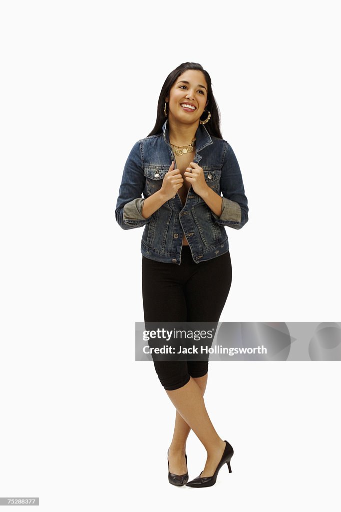 Young woman standing, smiling