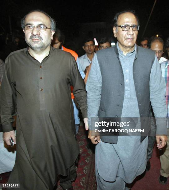 Pakistani Information Minister Mohammad Ali Durrani and former premier Chaudhry Shujaat Hussain arrive after holding talks with redical cleric Abdul...