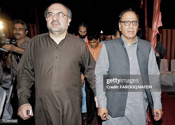 Pakistani Information Minister Mohammad Ali Durrani and former premier Chaudhry Shujaat Hussain arrive after holding talks with radical cleric Abdul...