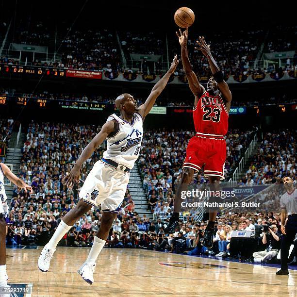 Michael Jordan of the Chicago Bulls shoots a jump shot against Bryon Russell the Utah Jazz in Game Six of the 1998 NBA Finals against the Chicago...