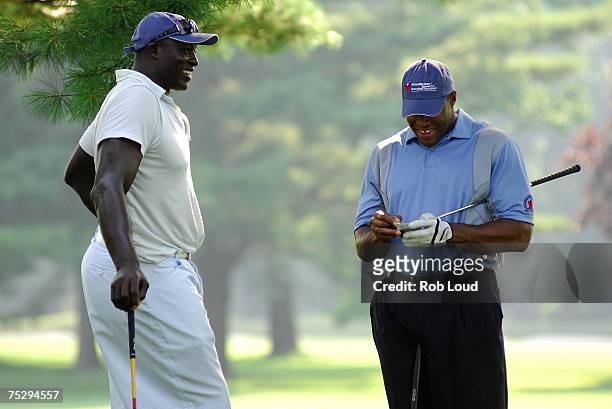 Former football players Bruce Smith and Michael Strahan compete in the Michael Strahan / Dreier LLP Charity Golf Tournament at the Century Country...