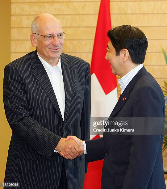 Swiss Vice President Pascal Couchepin shakes hands with Japanese Prime Minister Shinzo Abe during a courtesy call at the Prime Minister's official...