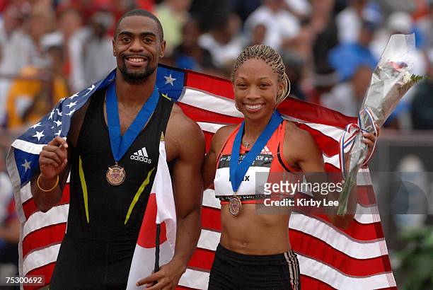 Tyson Gay and Allyson Felix, winners of the men's and women's 200 meters, pose with a United States flag in the USA Track & Field Championships at...