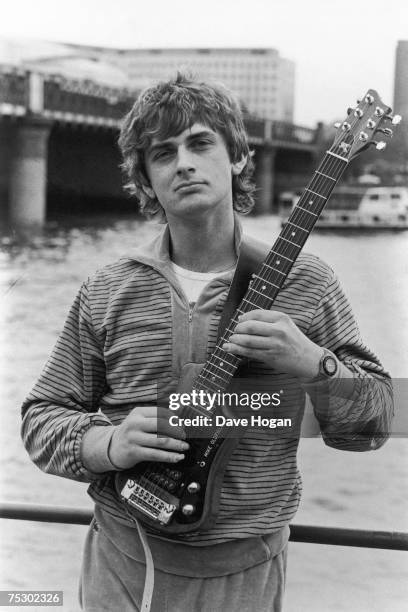 English multi-instrumentalist and composer Mike Oldfield with a personalised guitar, circa 1985.