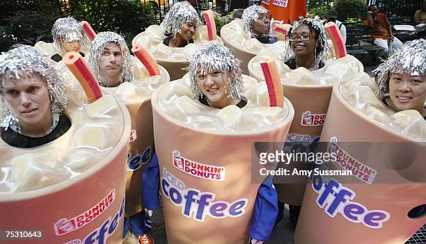 People in Iced Coffee costumes to help kick off Dunkin' Donuts' inaugural "Running Of The Cups" to celebrate those that serve the community at Herald...