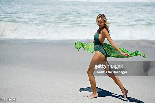 young woman in swimming costume, walking on the beach - sarong imagens e fotografias de stock