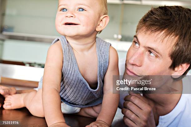 father and son in kitchen, indoors - brown hair blue eyes and dimples stock pictures, royalty-free photos & images