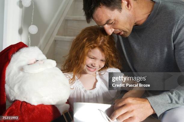 father and ldaughter opening christmas presents, indoors - dead girl stock pictures, royalty-free photos & images