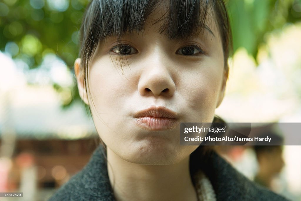 Young woman puckering lips
