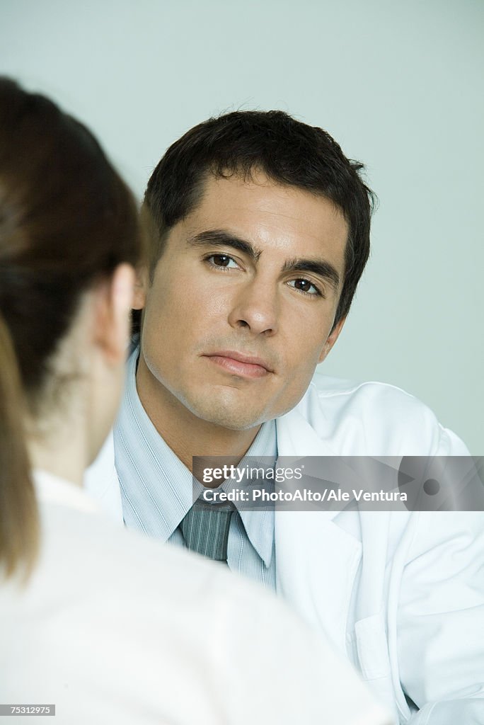 Doctor sitting across from female patient